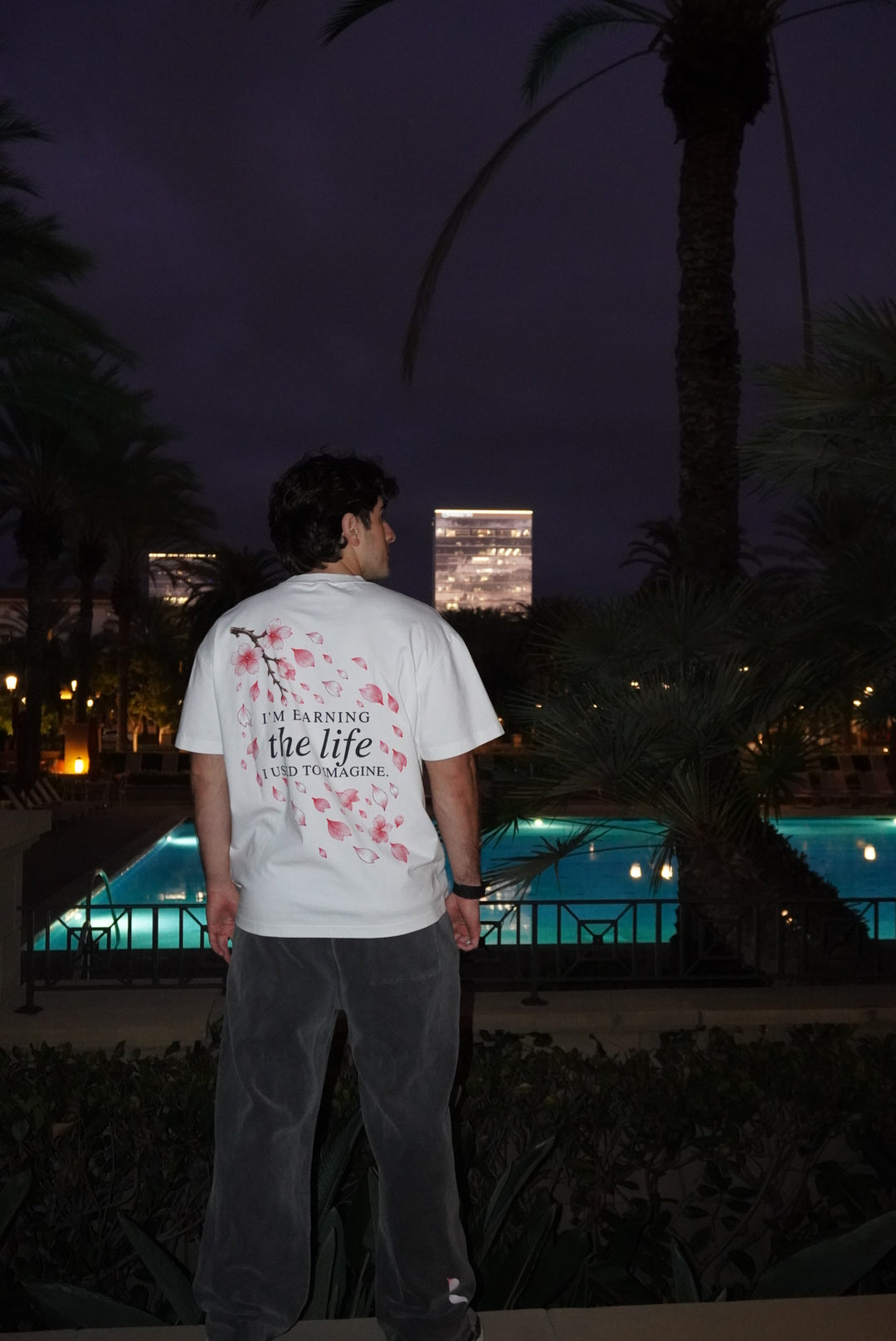 Cherry Blossom tee back print worn beside a pool at night