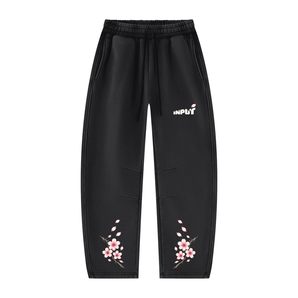 Front of the black INPUT Cherry Blossom Barrel sweatpants with pink blossom artwork